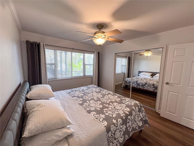 bedroom featuring ornamental molding, dark wood-type flooring, a closet, and ceiling fan