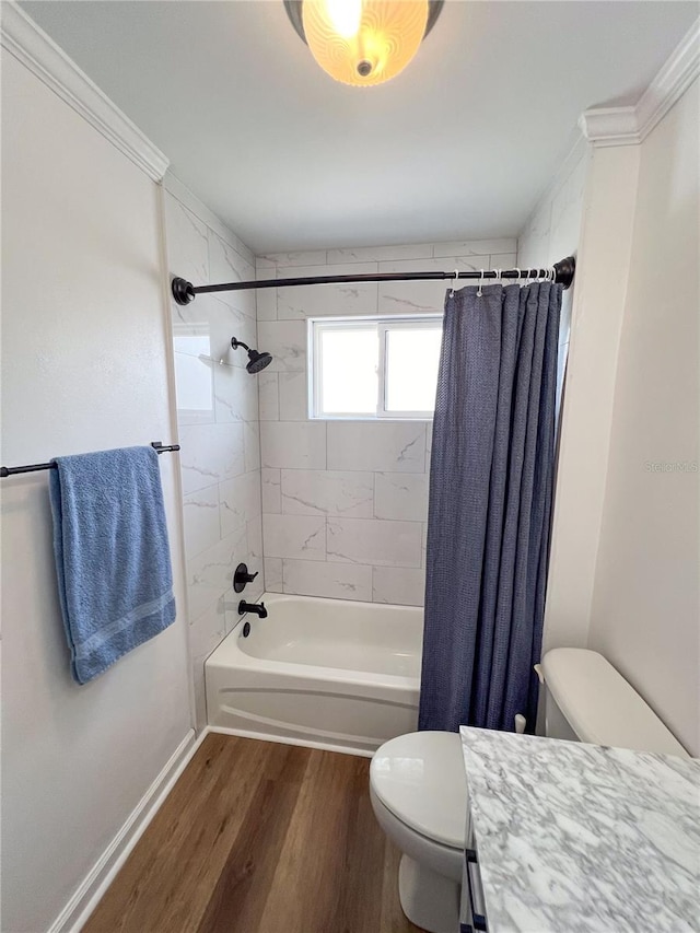 full bathroom with toilet, hardwood / wood-style floors, shower / tub combo with curtain, and ornamental molding