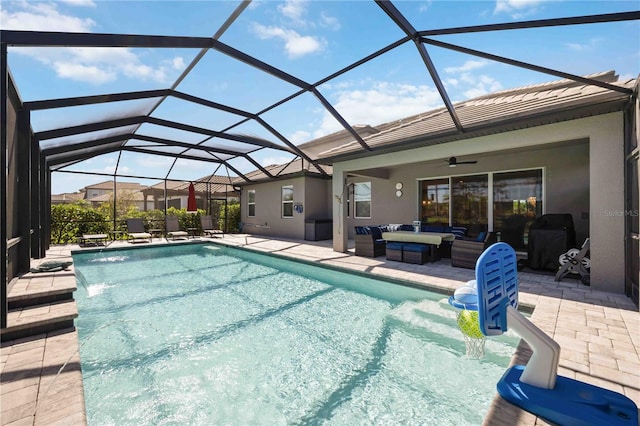 view of pool with a patio, ceiling fan, a lanai, and an outdoor living space