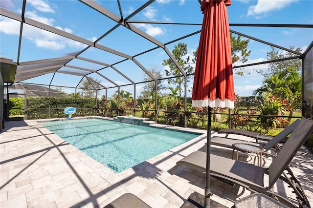 view of pool with a patio area and a lanai