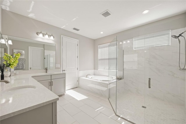 bathroom featuring vanity, independent shower and bath, and tile patterned floors