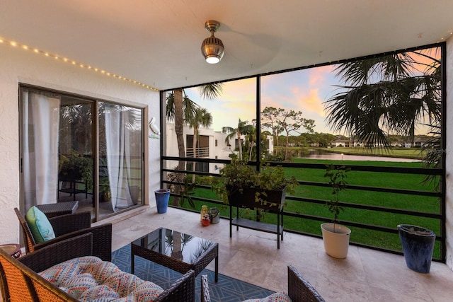 sunroom / solarium with a water view