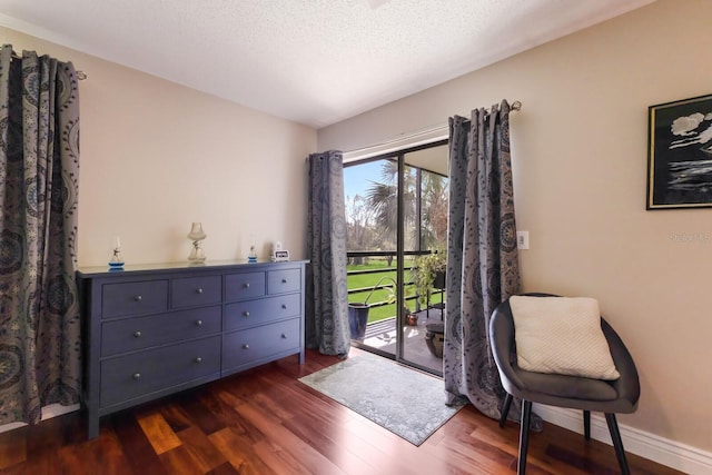 sitting room featuring dark hardwood / wood-style floors and a textured ceiling