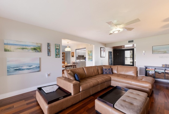 living room featuring ceiling fan and dark hardwood / wood-style flooring