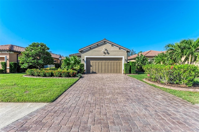 view of front of home with a front yard and a garage