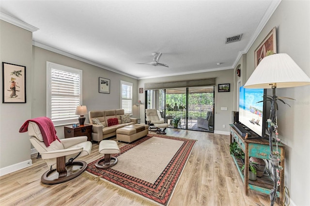 living room featuring crown molding, light hardwood / wood-style flooring, plenty of natural light, and ceiling fan