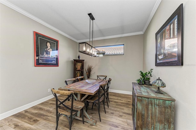 dining area featuring ornamental molding and hardwood / wood-style flooring