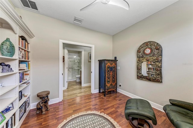 living area with dark wood-type flooring and a textured ceiling