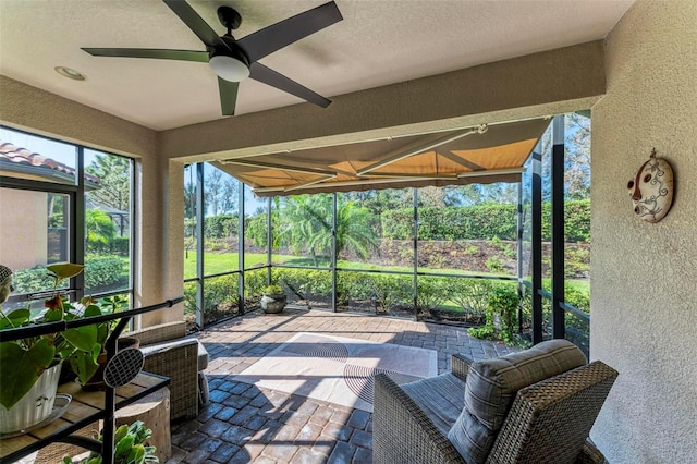 sunroom / solarium featuring ceiling fan