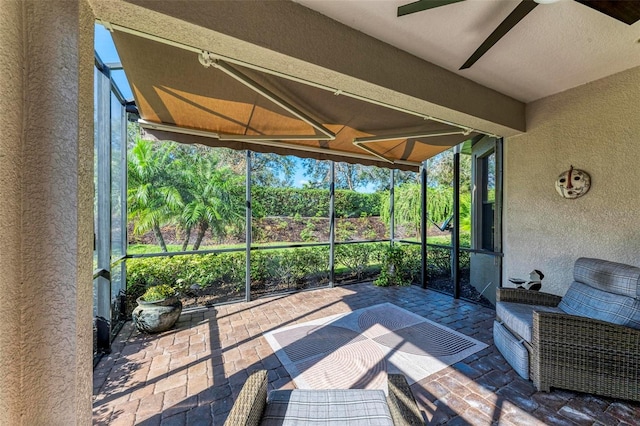 sunroom featuring ceiling fan