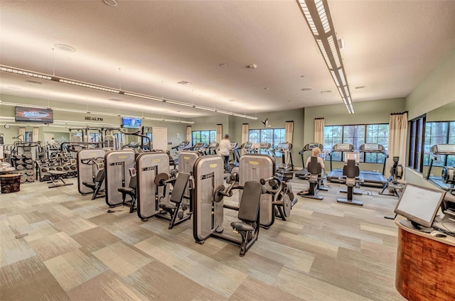 exercise room with light carpet