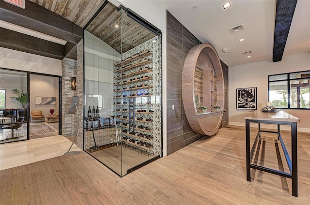 wine cellar with wood-type flooring and vaulted ceiling