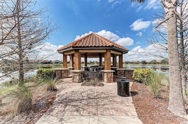 view of patio with a gazebo and a water view