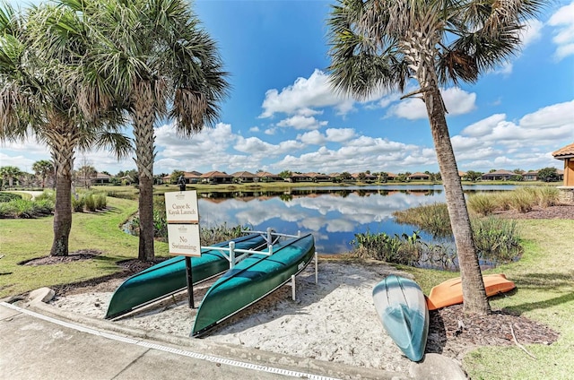 view of playground featuring a yard and a water view