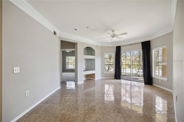 empty room featuring ceiling fan, ornamental molding, and built in shelves