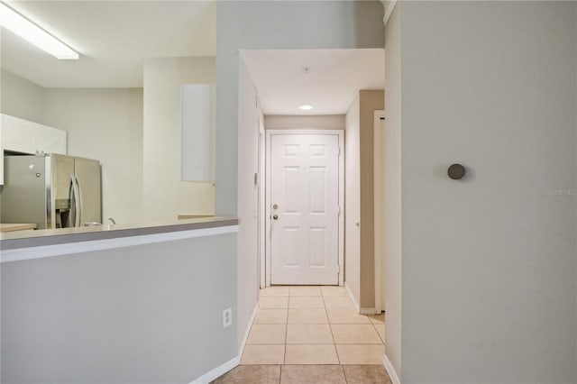 corridor with light tile patterned floors