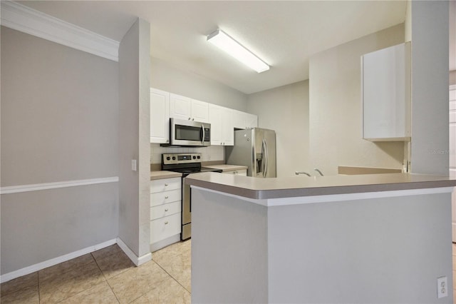 kitchen with kitchen peninsula, white cabinets, light tile patterned floors, ornamental molding, and stainless steel appliances