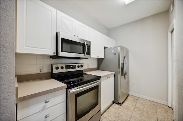 kitchen featuring decorative backsplash, appliances with stainless steel finishes, and white cabinetry