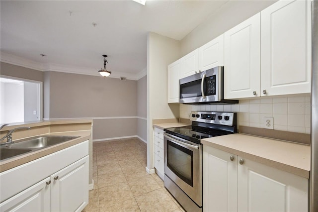 kitchen with backsplash, white cabinetry, sink, crown molding, and stainless steel appliances