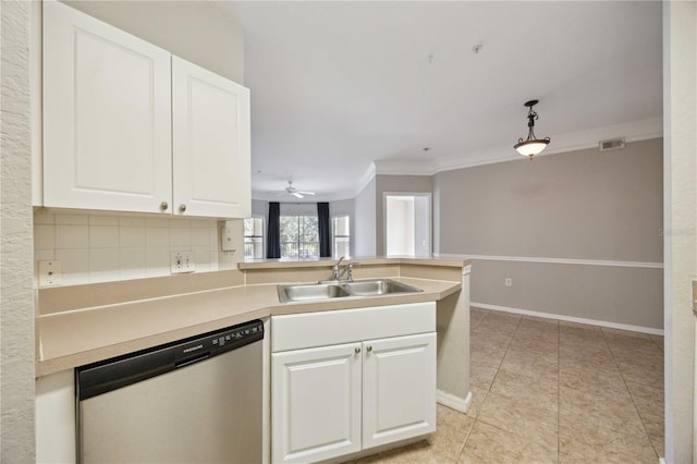 kitchen featuring sink, backsplash, white cabinetry, and dishwasher