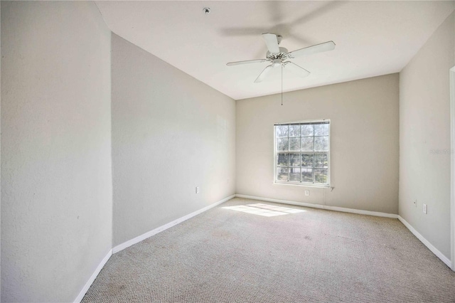 spare room with light carpet and ceiling fan