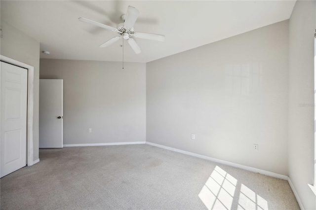 unfurnished bedroom with ceiling fan and light carpet