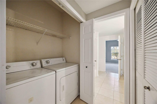 laundry area with light tile patterned flooring and washing machine and dryer