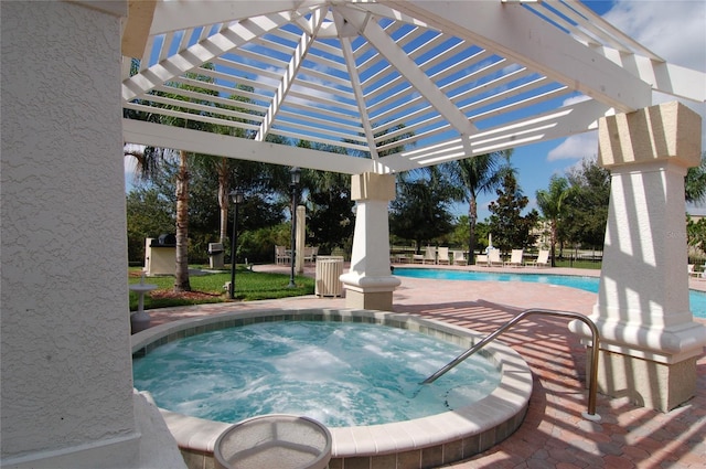 view of pool featuring a pergola and a hot tub