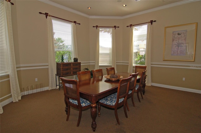 carpeted dining room with ornamental molding