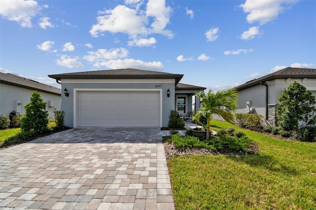 view of front of home with a front yard and a garage