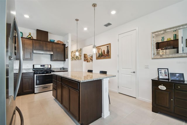 kitchen with a kitchen island, appliances with stainless steel finishes, dark brown cabinetry, and decorative light fixtures