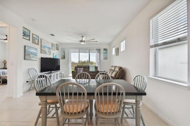 tiled dining space with ceiling fan