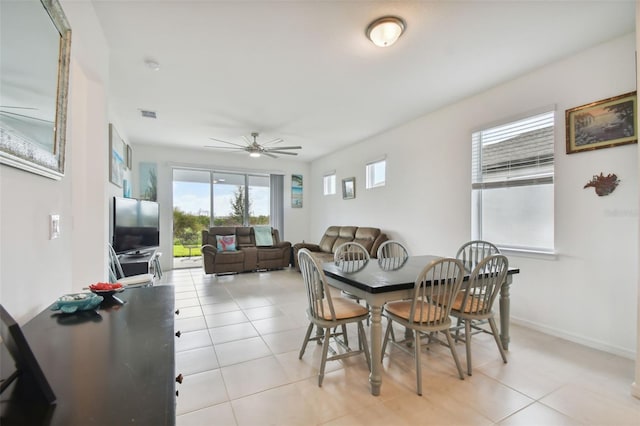 tiled dining space featuring ceiling fan