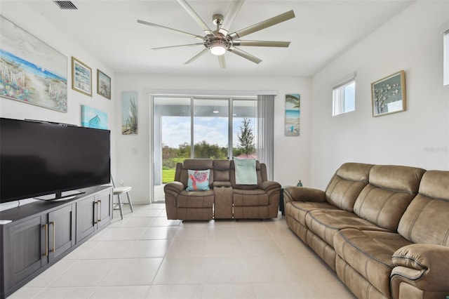 tiled living room with a healthy amount of sunlight and ceiling fan