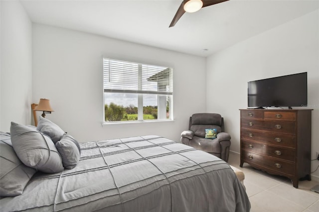 tiled bedroom featuring ceiling fan