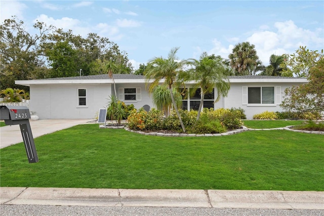 single story home with a front lawn