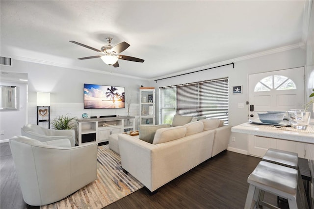 living room featuring ornamental molding, dark wood-type flooring, and ceiling fan