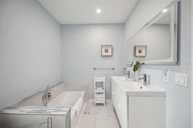 bathroom featuring vanity and a bath