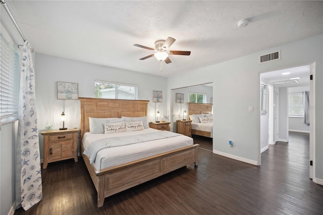 bedroom featuring a textured ceiling, dark wood-type flooring, and ceiling fan