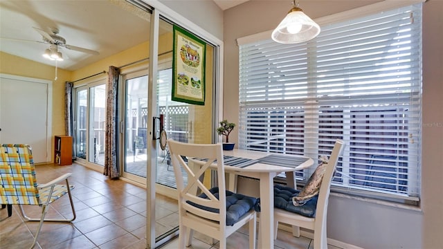 dining space with tile patterned flooring and a ceiling fan