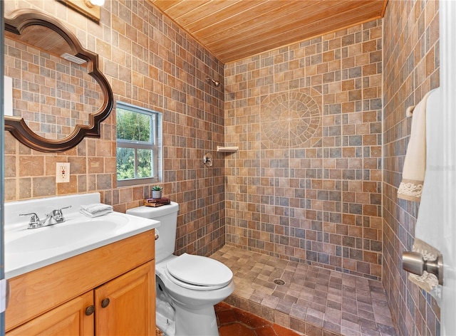 bathroom featuring toilet, tiled shower, wood ceiling, tile walls, and vanity