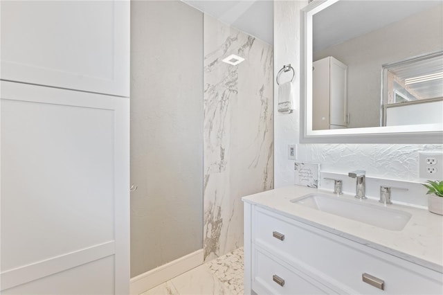 bathroom with vanity and marble finish floor
