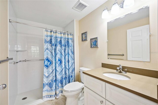 full bathroom with visible vents, vanity, toilet, and tiled shower