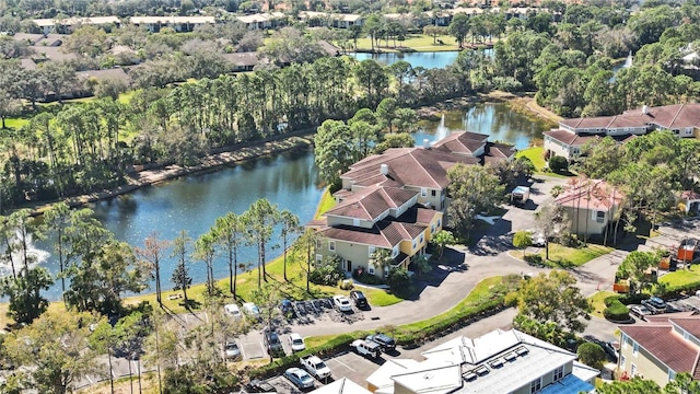 birds eye view of property with a water view and a residential view