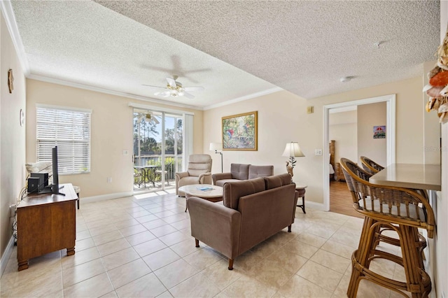 living room featuring ornamental molding, a ceiling fan, and light tile patterned flooring