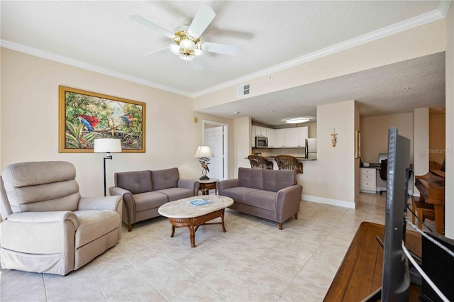 living room with a textured ceiling, ornamental molding, and visible vents