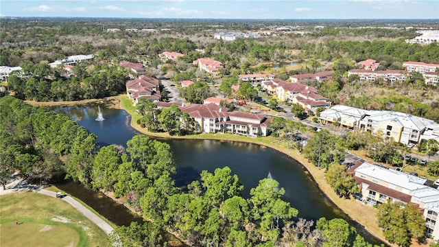 aerial view with a water view and a view of trees