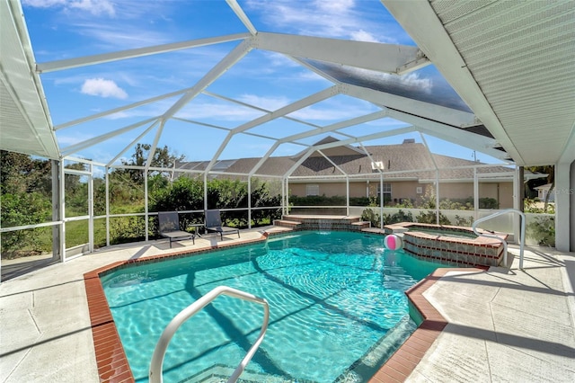 view of pool featuring an in ground hot tub, a patio, and glass enclosure