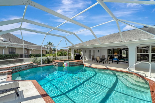 view of swimming pool with an in ground hot tub, a patio, and glass enclosure