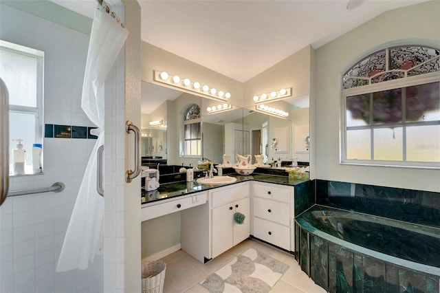 bathroom featuring vanity, a healthy amount of sunlight, tile patterned flooring, and vaulted ceiling